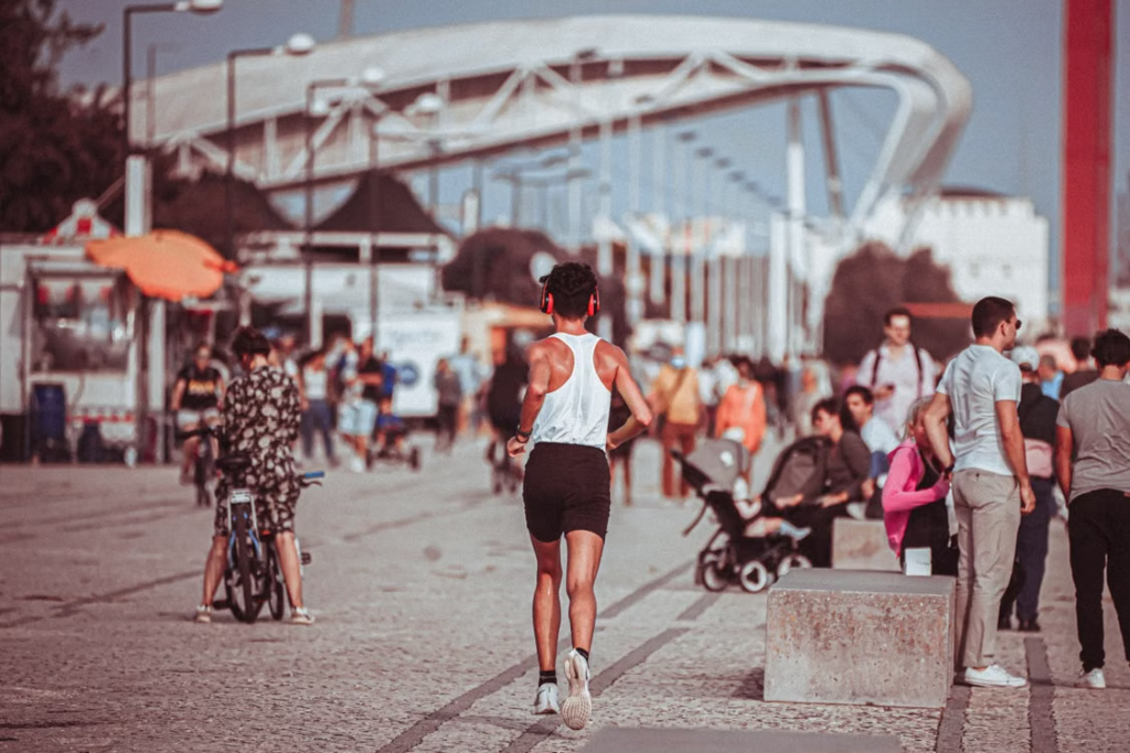 Runner exercising outdoors along a busy waterfront promenade